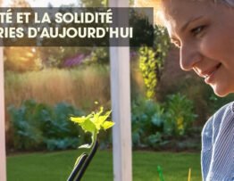 Woman examining an irrigation timer in a garden